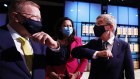 President of the International Olympic Committee Thomas Bach (right) bumps elbows with AOC president John Coates and Queensland Premier Annastacia Palaszczuk.