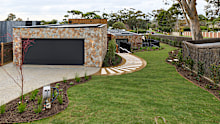 Shaynna’s first word upon seeing the team’s front yard was a simple, “Wow”. She was immediately taken by the stone work on the garage, as was Darren Palmer, who called the colour and texture “perfect”.