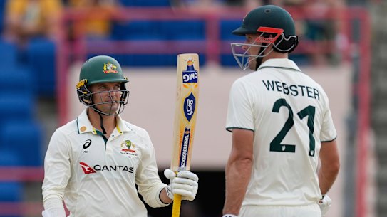 Alex Carey celebrates with partner Beau Webster scoring a half-century against the West Indies during day one of the second cricket Test match.