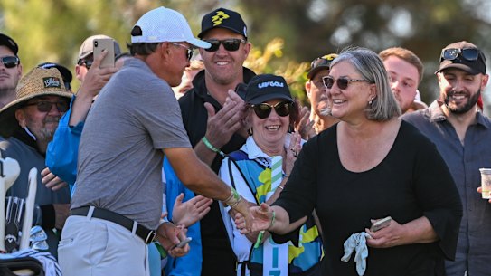 Phil Mickelson hands his glove to a fan during the second day of the LIV Adelaide event.
