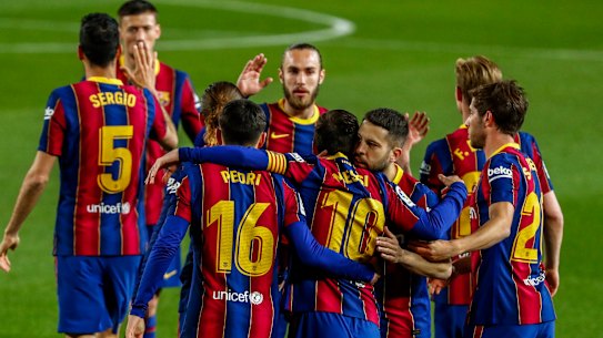Lionel Messi is congratulated by Barcelona teammates after scoring against Getafe on Thursday (Friday AEST).
