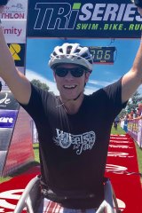 Double amputee Toby Lyndon crosses the finish line to complete his first triathlon.