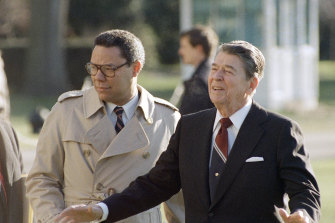 President Ronald Reagan, right, and national security adviser Colin Powell leave the White House in 1988.