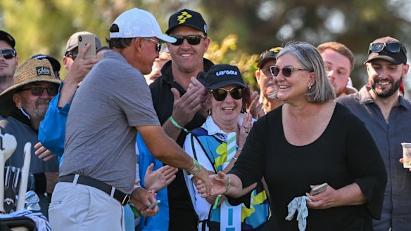 Phil Mickelson hands his glove to a fan during the second day of the LIV Adelaide event.