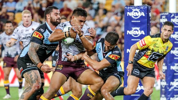 Brute force: Joe Ofahengaue powers over the line for the Broncos at Suncorp Stadium.