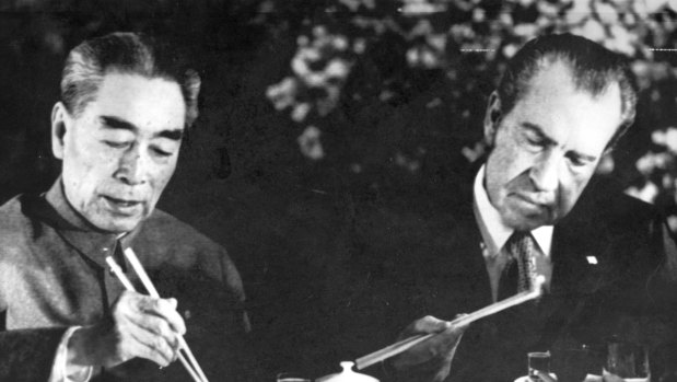 US President Nixon eats with chopsticks at dinner in Shanghai with Premier Chou En-lai AKA Zhou Enlai as he wound up his China visit in 1972.