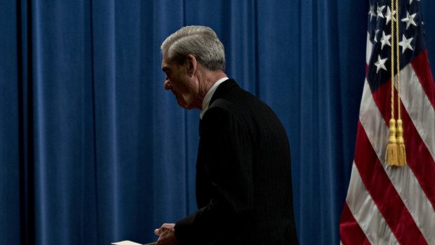Special counsel Robert Mueller exits after speaking at the Department of Justice.