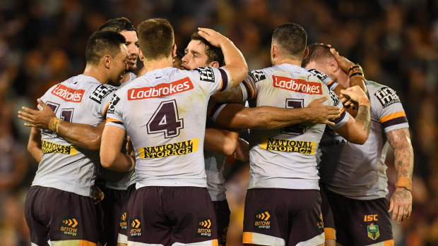 Sickener: The Broncos celebrate their controversial golden-point victory over the Tigers in round three.