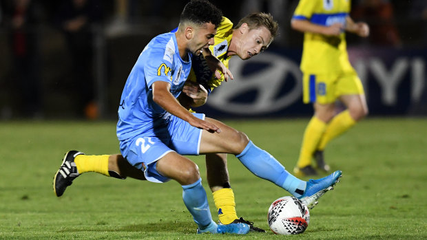 Ramy Najjarine of Melbourne City, left, and Fraser Hills of the Strikers compete for the ball.
