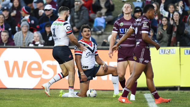 Beaten all ends up: Latrell Mitchell  scores as the Roosters pile on the points against Manly.