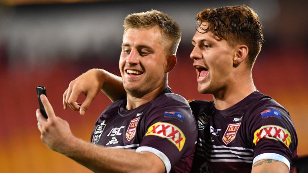 Picture perfect: Cameron Munster and Kalyn Ponga celebrate after the Maroons' victory on Wednesday.