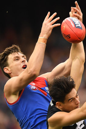 On the climb: Jake Lever gets up over Carlton's Zac Fisher, as Melbourne move into the top four after crushing the Blues.