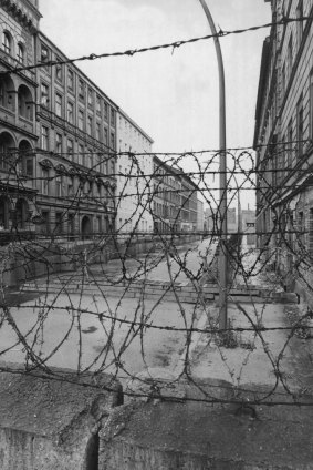 View across the barbed wire entanglements which top the wall into Sebastian Strasse between East and West Berlin.