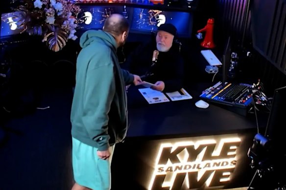 Kyle Sandilands was served with subpoena papers live on air by his manager, Bruno Bouchet.