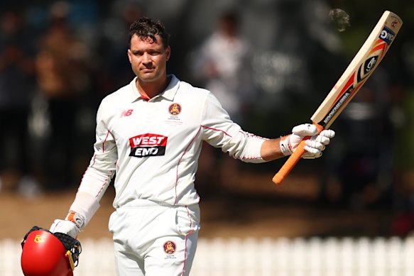 Alex Carey reaches his century on day four of the match.