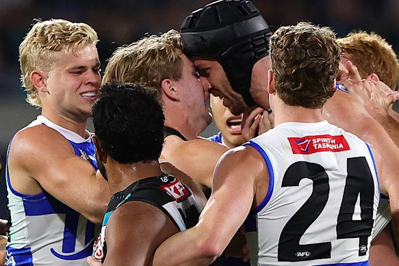Tempers flared between Tristan Xerri (in helmet) of the Kangaroos and Jason Horne-Francis of the Power.