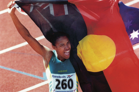 Cathy Freeman famously carries the Aboriginal flag alongside that of Australia at the 1994 Commonwealth Games in Canada.