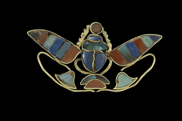 Ornament of a winged scarab holding a sun disc.