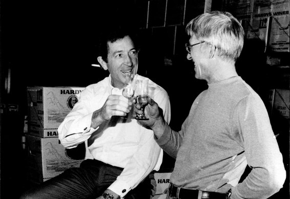 James Hardy celebrates his knighthood with Noel Bird, distribution manager of Thomas Hardy Wines at his NSW headquarters at Botany, 1981.