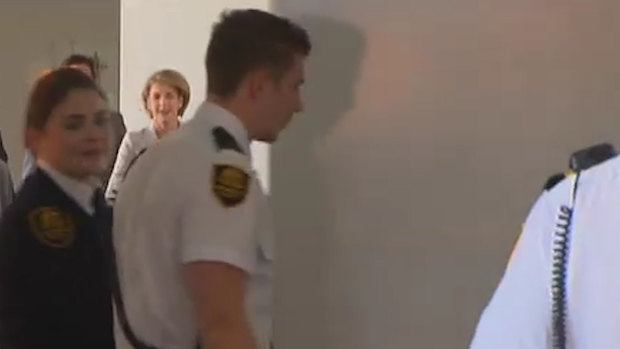 A whiteboard is used to screen Jobs Minister Michaelia Cash from the media as she enters a committee room at Parliament House on Thursday.