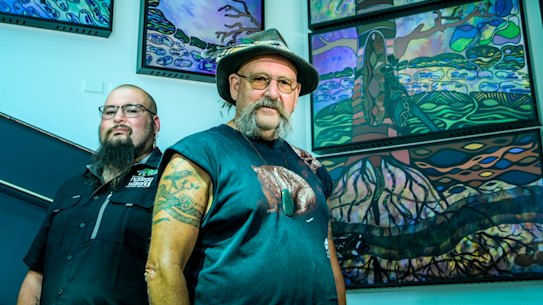 Indigenous artist Mick Harding, in front of his video installation for ACMI, with his son Mitch who worked on the piece with him.