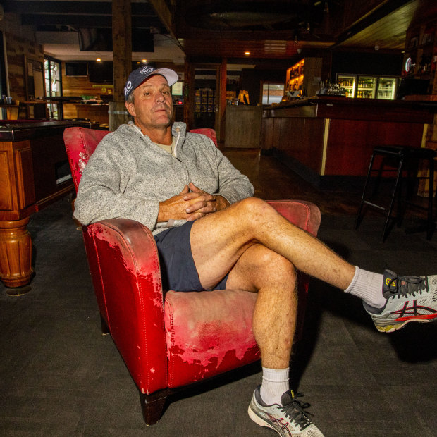 Mallacoota Hotel owner Lou Battel sits in the empty bar.