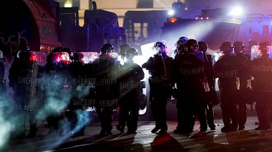 Authorities disperse protesters out of a park Tuesday, Aug. 25, 2020 in Kenosha, Wis. Anger over the Sunday shooting of Jacob Blake, a Black man, by police spilled into the streets for a third night. (AP Photo/Morry Gash)