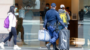 Travellers  returning from overseas escorted to hotel quarantine in Sydney.