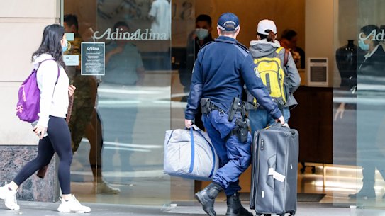 Travellers  returning from overseas escorted to hotel quarantine in Sydney.