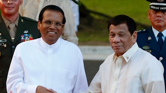 Like-minded: Sri Lanka President Maithripala Sirisena, left, and Philippine President Rodrigo Duterte shake hands in Manila last month.