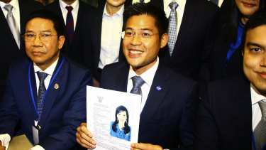 Thai Raksa Chart party leader Preecha Pholphongpanich holds a picture of Princess Ubolratana, announcing she will be their prime ministerial candidate.