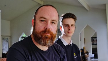 Travis Tait and his son Xander who is sitting his year 12 exams while power has been cut to their home in Montrose.