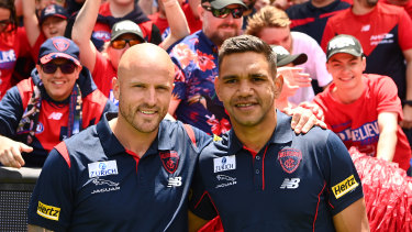 Nathan Jones and Neville Jetta celebrate with the Demons faithful at the MCG last December.