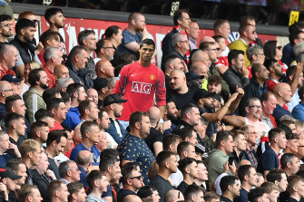 Manchester United fans hold up a cardboard cutout of returning superstar Cristiano Ronaldo during their game at Wolverhampton Wanderers on Sunday.