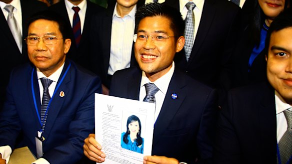 Thai Raksa Chart party leader Preecha Pholphongpanich holds a picture of Princess Ubolratana, announcing she will be their prime ministerial candidate.