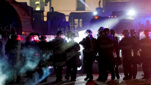 Police dispersing protesters out of a park in Kenosha on the third night of protests.