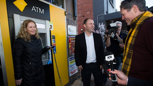 Mr Frydenberg, the member for Kooyong, talks to constituents outside.