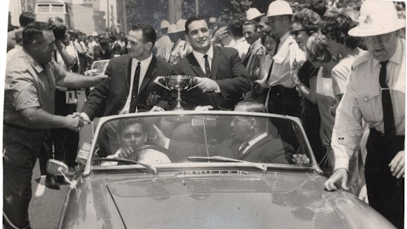 Summons and Ian Walsh parade the Ashes Cup through the streets of Sydney on their triumphant return to Australia in 1964.