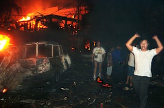 Residents and tourists at the scene of the Bali terrorist attacks of 2002.