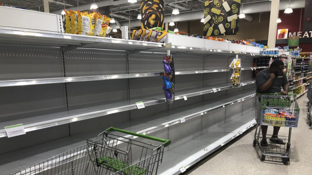 Empty shelves where water is usually stocked at a grocery store in Miami, Florida. 