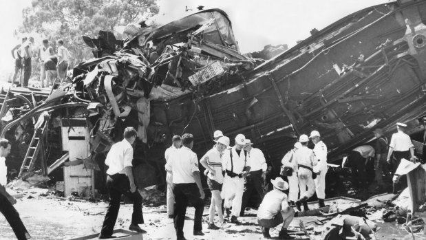 Rescue workers searching the tangled wreckage of the two trains.