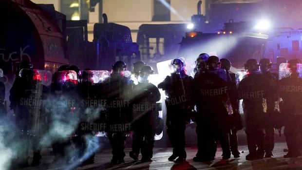 Police dispersing protesters out of a park in Kenosha on the third night of protests.