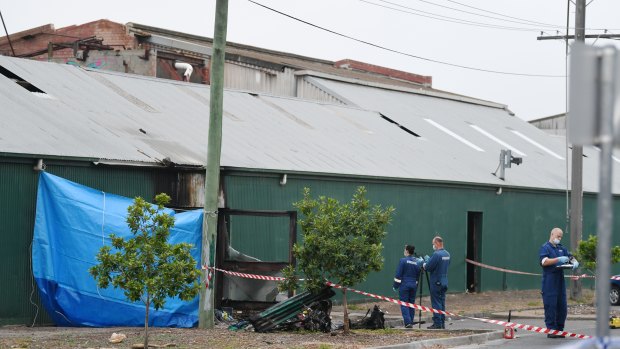 Police and forensic officers at the scene of the abandoned factory the day after the fire in March 2017.