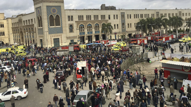 People gathering outside Ramses train station in Cairo after the accident.