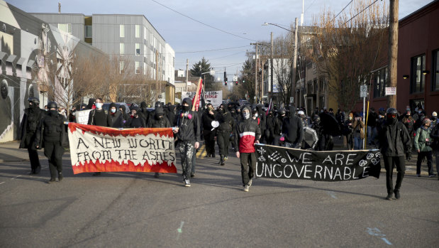 Demonstrators march during a protest on Inauguration Day in Southeast Portland.