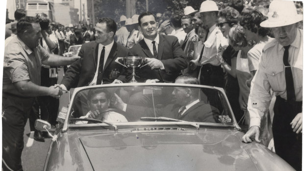Summons and Ian Walsh parade the Ashes Cup through the streets of Sydney on their triumphant return to Australia in 1964.
