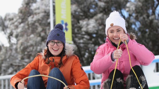 Fun times: Hope Dyson, left, and Rosie Bennett on the Village toboggan slope at Mt Buller in May.