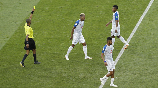 Panama's Edgar Barcenas, top right, is shown a yellow card against Belgium