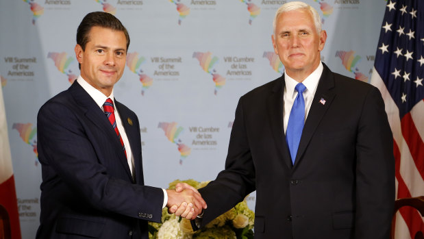US Vice-President Mike Pence, right, shakes hands with Mexico's President Enrique Pena Nieto during a bilateral meeting at the Summit of the Americas in Lima, Peru, on Saturday.