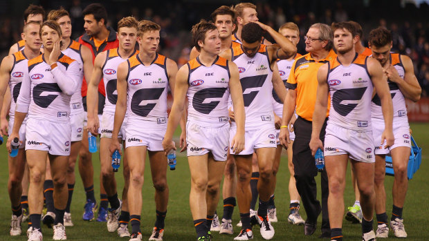 Kevin Sheedy and his GWS side walk off the ground after a loss to Carlton in 2013. 